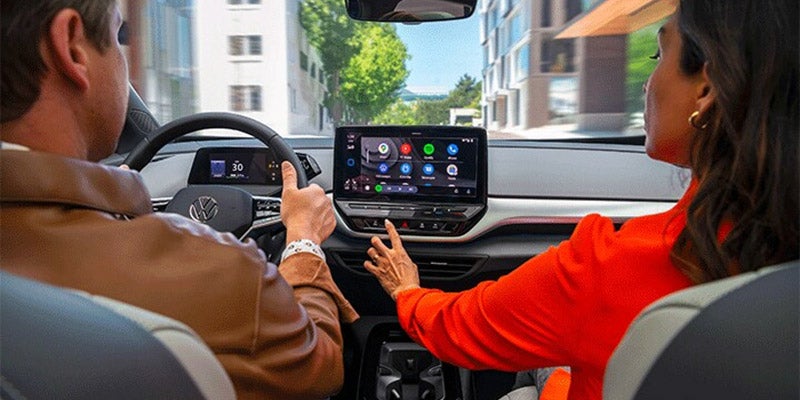 Interior view of couple driving a VW vehicle