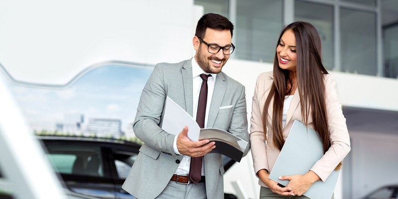 Smiling dealership staff members
